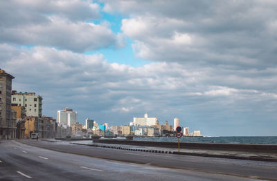 Buildings by sea against sky in city