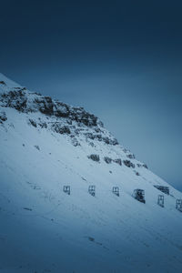 Scenic view of snowcapped mountains against clear blue sky