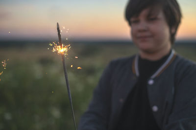 Portrait of young man standing against sky during sunset