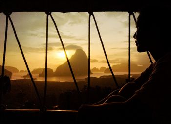 Silhouette man against orange sky