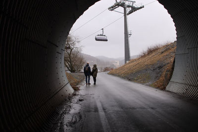 Rear view of people walking on road