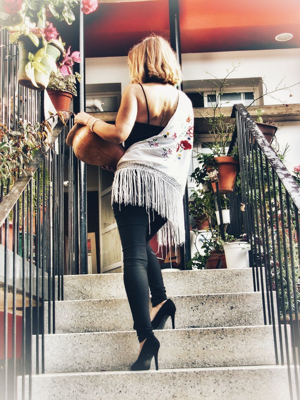 WOMAN STANDING ON STAIRCASE