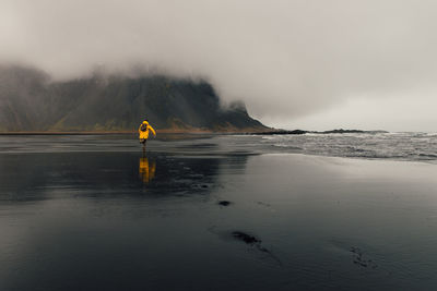 Person on yellow land against sky