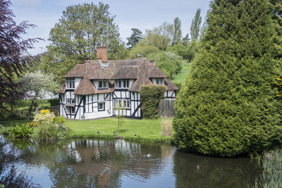 Pretty half timbered cottage in the village of loose, kent, uk with  loose river in the foreground