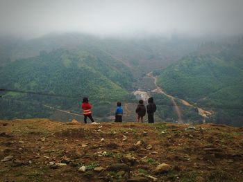 Rear view of man standing on mountain