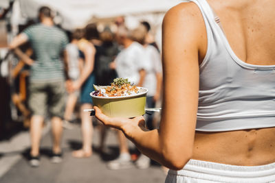 Midsection of woman holding food