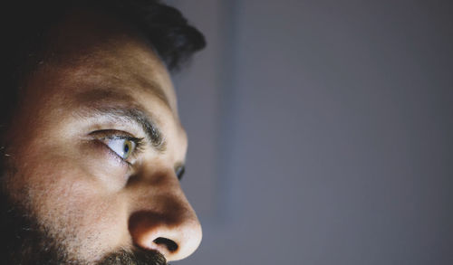 Close-up portrait of young man looking away