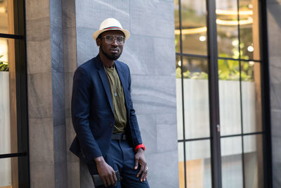 Man standing against wall in city