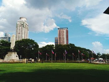 Trees in city against sky