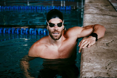 Portrait of young man swimming in pool