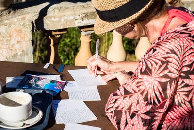 Woman writing postcards