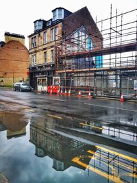 Reflection of building in puddle