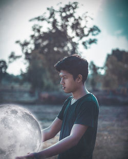 Side view of young man looking away