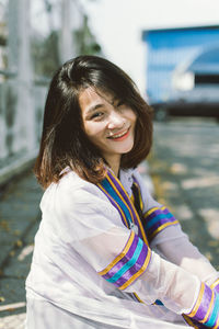 Portrait of beautiful smiling woman in city