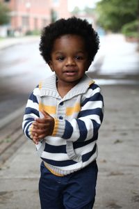 Portrait of smiling boy standing outdoors