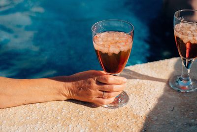 Close-up of hand holding beer glass