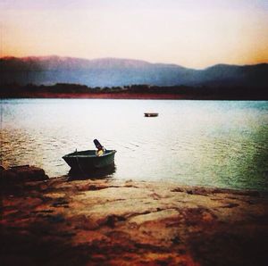 Scenic view of calm lake at sunset