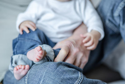 Midsection of child holding hands