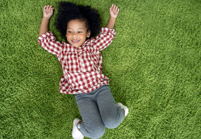 Portrait of a smiling boy on green landscape