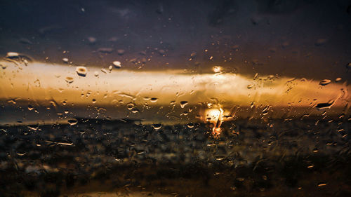 Full frame shot of wet glass window during rainy season