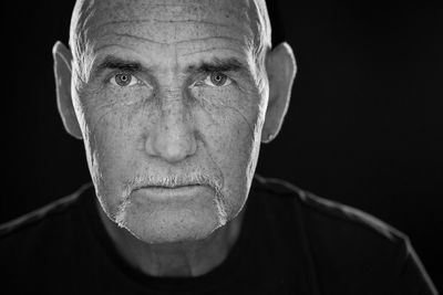 Close-up of man over black background