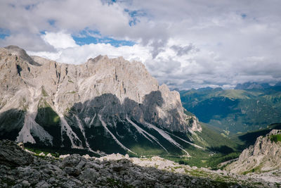 Panoramic view of mountain range against cloudy sky