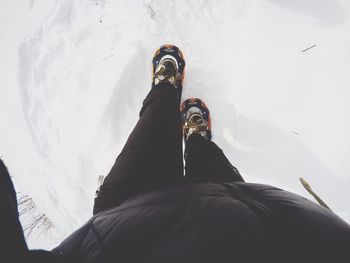 Low section of person hiking on snow