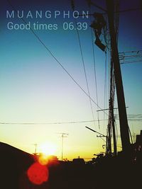 Low angle view of silhouette cables against clear sky