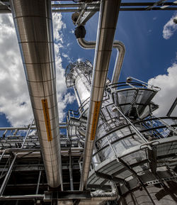 Low angle view of industry against sky