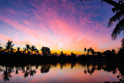 Scenic view of lake against sky at sunset