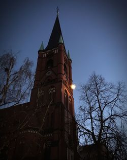 Low angle view of clock tower against sky