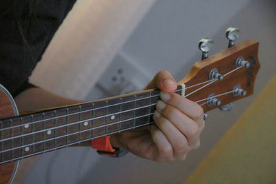 Close-up of hand playing guitar