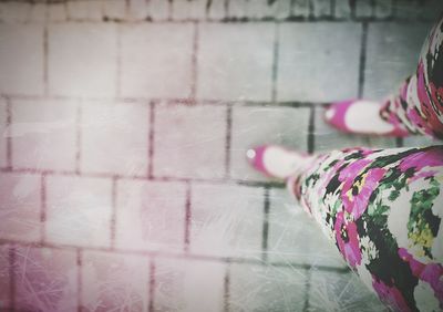 Low section of woman standing on tiled floor