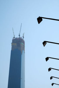 Low angle view of crane against clear sky