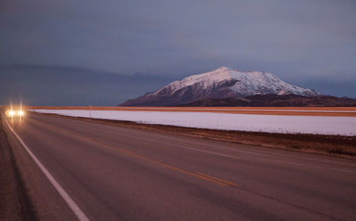 Beautiful snowy mountain and road at dusk, utah, usa