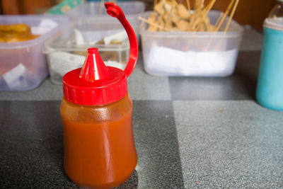 A bottle of hot sauce on the school canteen table