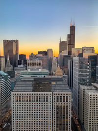 Modern buildings in city during sunset