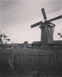 Traditional windmill on field against sky