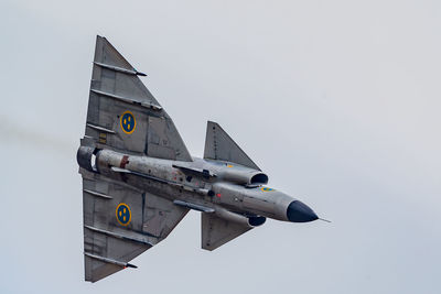 Low angle view of airplane against clear sky