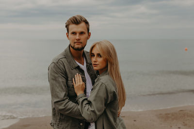 Love story of a young boy and girl. solitude with the sea one on one. baltic sea, sand and silence.