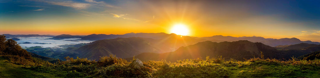 Scenic view of mountains against sky during sunset