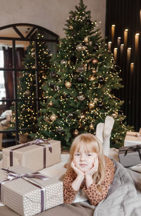 Portrait of smiling young christmas tree at home