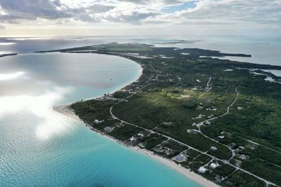 Aerial view of swimming pool by sea against sky