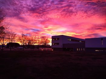 Exterior of houses against cloudy sky during sunset