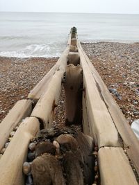 High angle view of pebbles on beach against sky