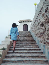 Low angle view of woman standing on steps