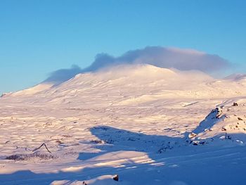 Scenic view of snowcapped mountains against clear sky