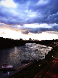 Scenic view of river against cloudy sky