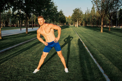 Full length of man exercising on field