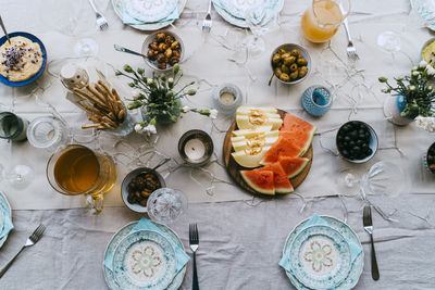 Directly above shot of fresh fruits and drinks arranged on table